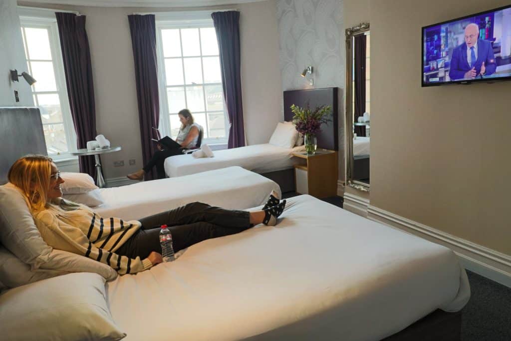 Two women relaxing in their triple room at the Jackson Court Hotel